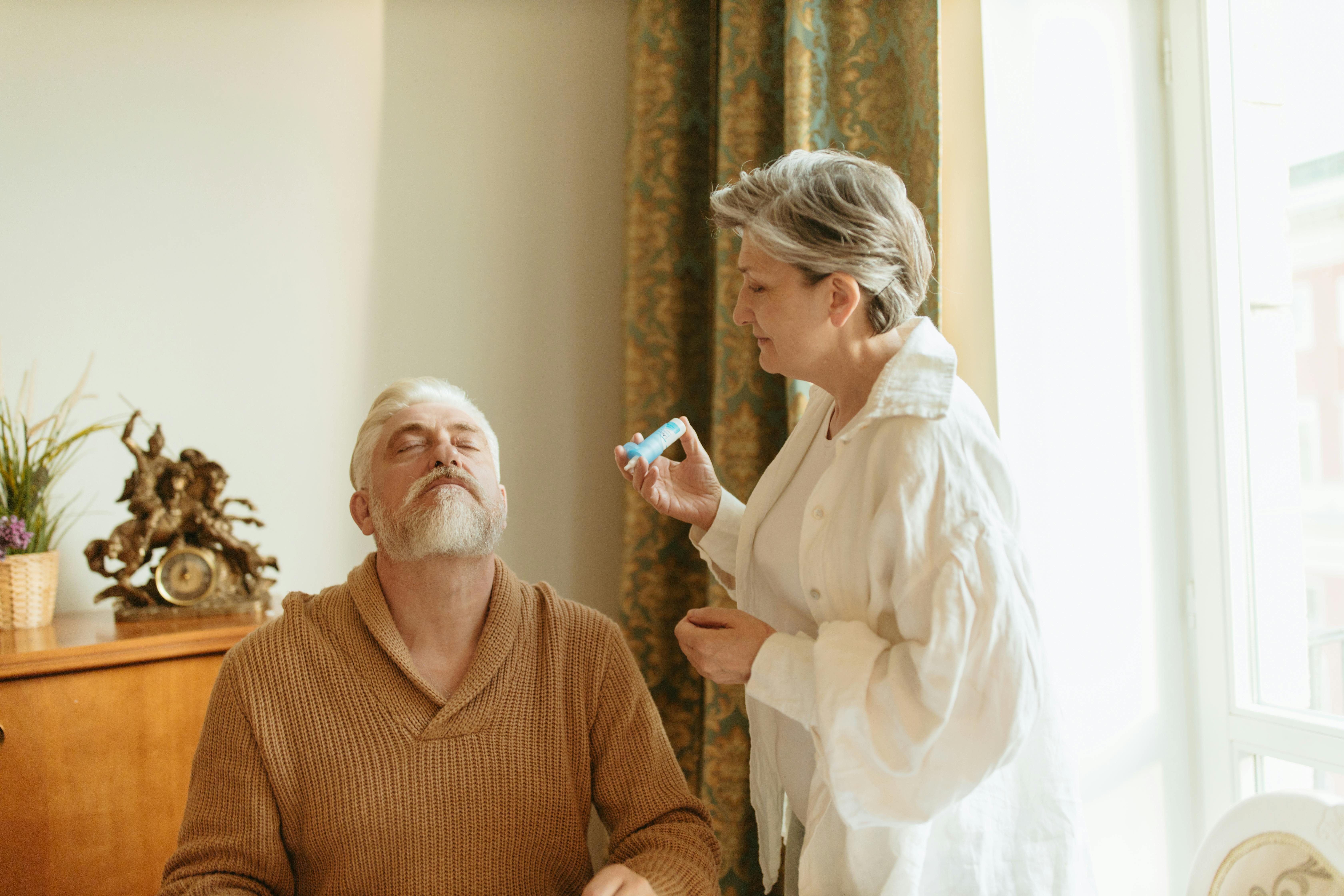 Caregiver assisting elderly couple with coloring